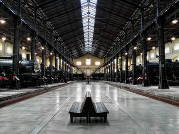 Empty benches in illuminated building