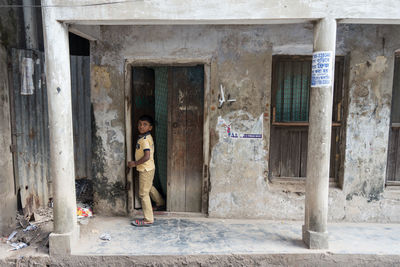 Man standing by door of building