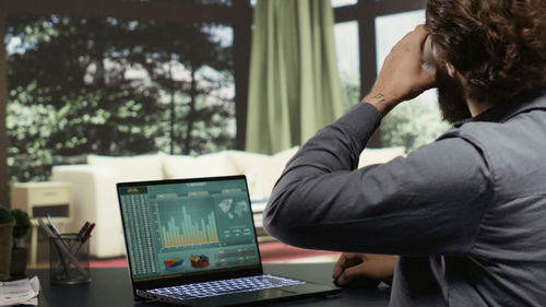 Young man using laptop at home