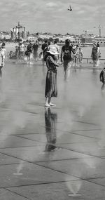 Woman  standing on water mirror installation