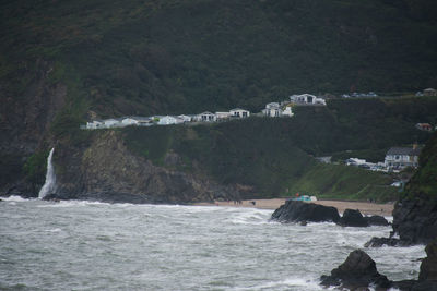 Scenic view of sea by mountains