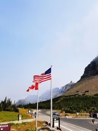 Flag flags on landscape against clear sky