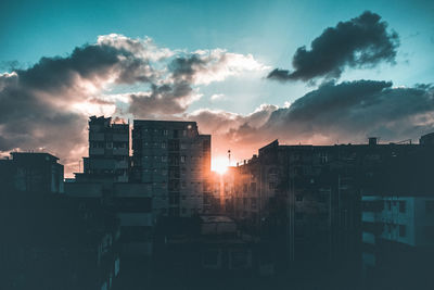 Silhouette buildings against sky during sunset