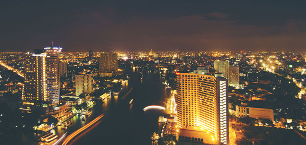 Aerial view of illuminated buildings in city at night