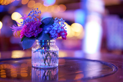 Close-up of flowers in glass on table