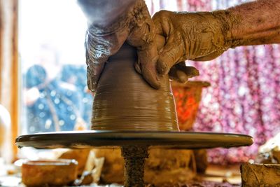 Cropped image of hand making pots