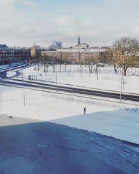 Scenic view of snow covered city against sky