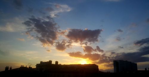 Silhouette buildings at sunset