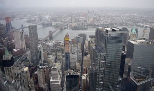 High angle view of modern buildings in city against sky