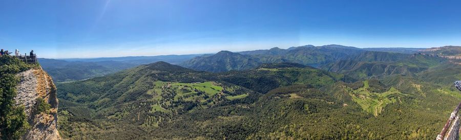 Scenic view of mountains against blue sky