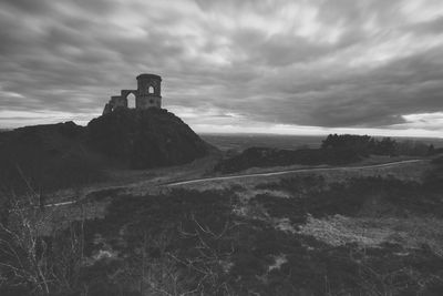 Mid distance view of mow cop castle against cloudy sky