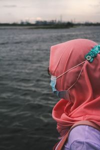 Rear view of person on boat in sea