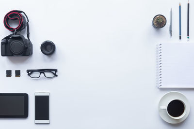 High angle view of camera on table against white background