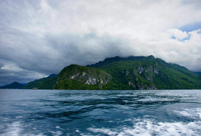 Scenic view of sea and mountains against sky