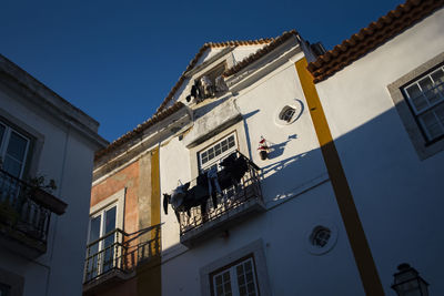 Low angle view of residential building against blue sky