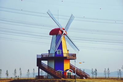 Low angle view of traditional windmill against sky