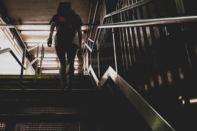 Rear view of woman walking on staircase