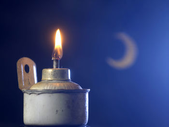 Oil lamp with crescent on the blue background