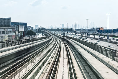 High angle view of railroad tracks in city against sky