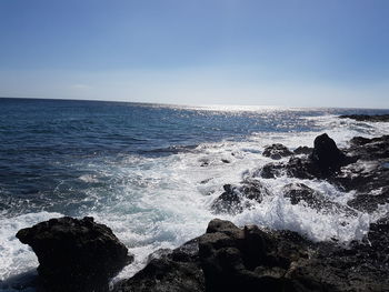 Scenic view of sea against clear blue sky