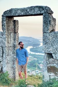 Full length of man standing against built structure