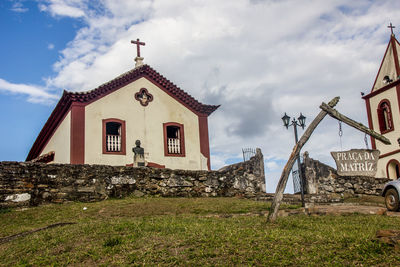 Exterior of house by building against sky