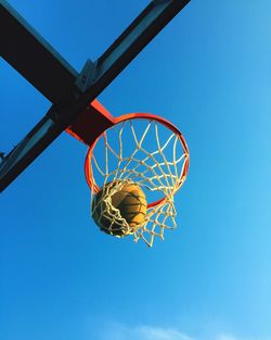 Low angle view of basketball hoop against blue sky