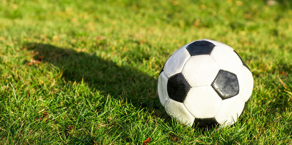 Close-up of soccer ball on field