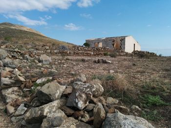 Scenic view of abandoned house and mountains against sky