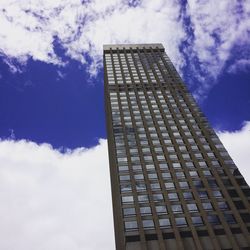 Low angle view of modern building against cloudy sky