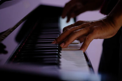 Cropped hand playing piano