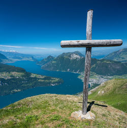 Cross on mountain against blue sky