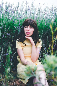 Young woman sitting on field