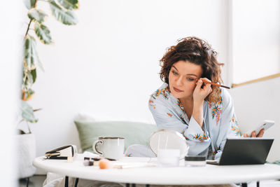 Young woman using laptop at table