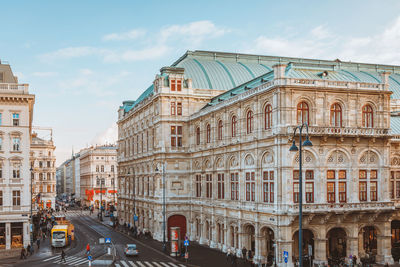 View of city street and buildings against sky
