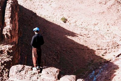 Full length rear view of man on rock