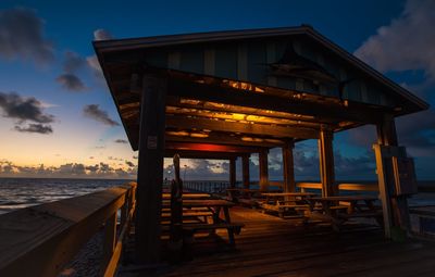 Pier over sea against sky during sunset