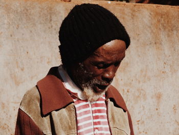 Portrait of young man against wall