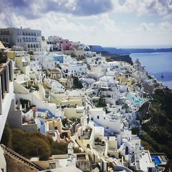 High angle view of town by sea against sky