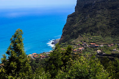 High angle view of trees and sea against sky