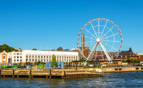 Ferris wheel against clear blue sky