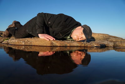 Low angle view of man standing in lake