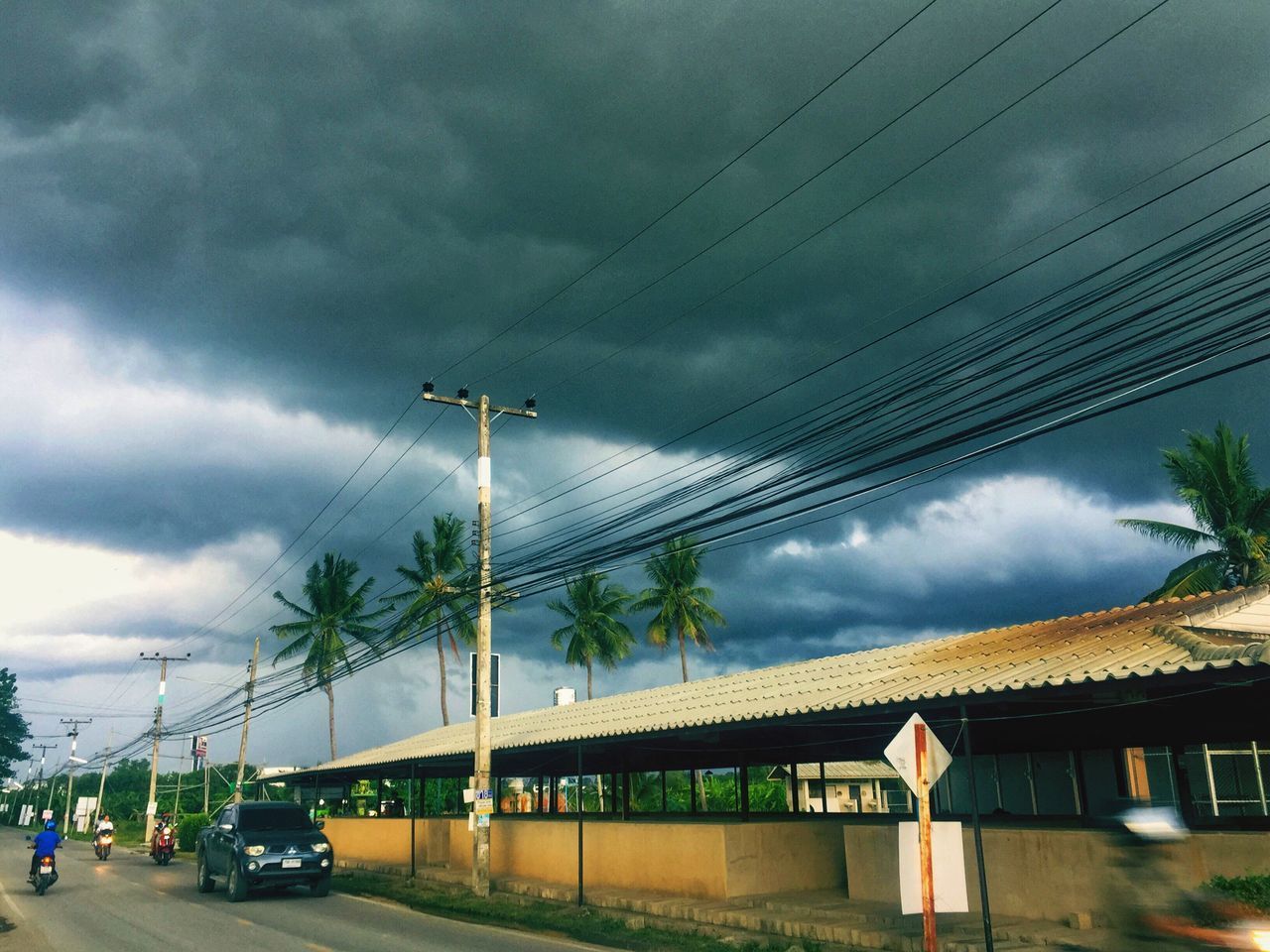 LOW ANGLE VIEW OF CAR ON STREET AGAINST SKY