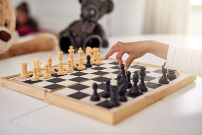 Cropped hand playing chess