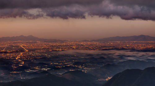 Aerial view of cityscape against sky during sunset