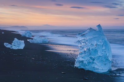 Ice lying on black volcanic beach. iceland