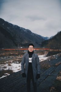 Portrait of man standing in snow