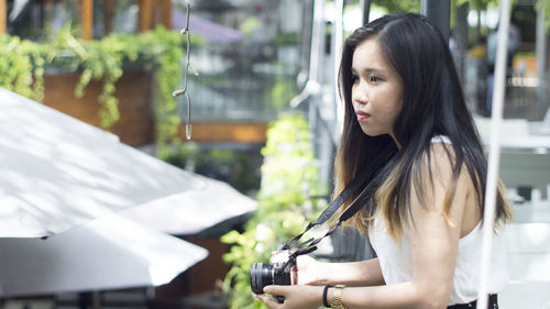 Portrait of young woman looking at camera