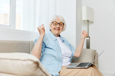 Young woman using laptop at home