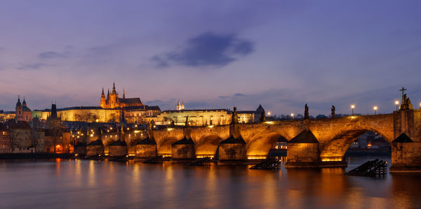 View of bridge over river at dusk